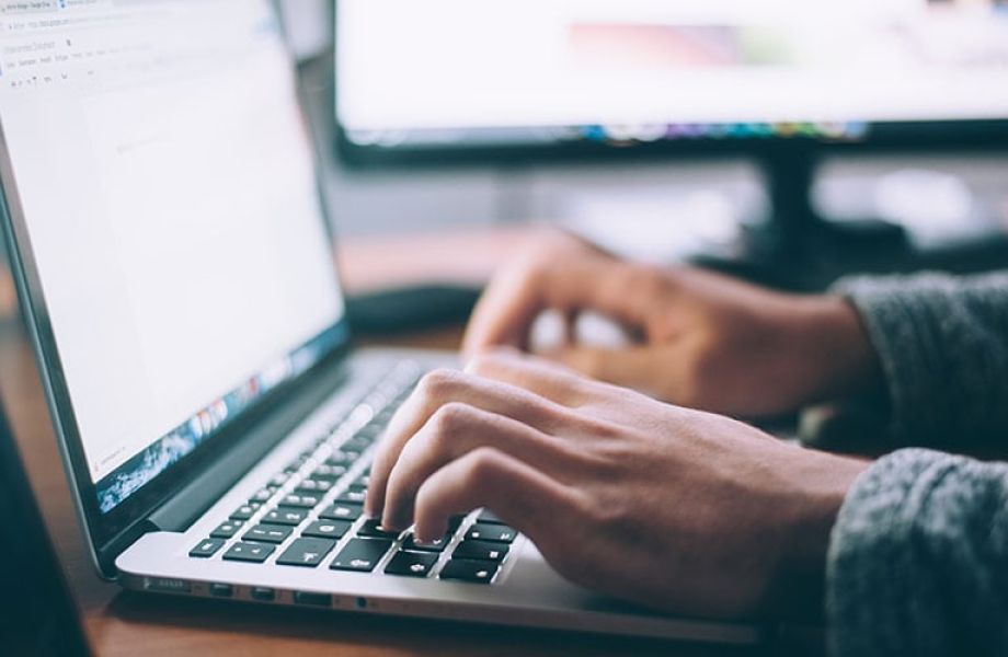 An open laptop on which an employee is working